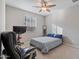 Bedroom with a comfortable bed, ceiling fan, and office chair at 22918 E Marsh Rd, Queen Creek, AZ 85142