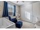 Bedroom with a crib, chair, and ample closet space at 22918 E Marsh Rd, Queen Creek, AZ 85142