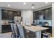 Island kitchen with granite countertops, dark cabinetry, and stainless steel appliances at 22918 E Marsh Rd, Queen Creek, AZ 85142