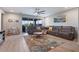 Spacious living room with sectional sofa, large windows, and ceiling fan at 22918 E Marsh Rd, Queen Creek, AZ 85142
