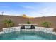 Stunning waterfall feature in a modern, tiled pool setting at 22918 E Marsh Rd, Queen Creek, AZ 85142