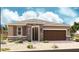 One-story home with stone accents, brown garage door, and landscaped yard at 2569 N 196Th Dr, Buckeye, AZ 85396