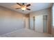 Bedroom with ceiling fan, closet and carpet at 42575 W Abbey Rd, Maricopa, AZ 85138