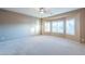 Bright bedroom with bay window and ceiling fan at 42575 W Abbey Rd, Maricopa, AZ 85138