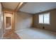Spacious bedroom with carpet and access to hallway at 42575 W Abbey Rd, Maricopa, AZ 85138
