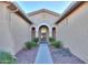 Front entry with arched doorway and walkway between two walls at 42575 W Abbey Rd, Maricopa, AZ 85138