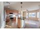 Kitchen with island, stainless steel appliances, and wood cabinets at 42575 W Abbey Rd, Maricopa, AZ 85138