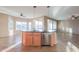 Open kitchen with large island, granite countertops, and breakfast bar at 42575 W Abbey Rd, Maricopa, AZ 85138