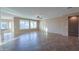 Spacious living room with tile floors and large windows at 42575 W Abbey Rd, Maricopa, AZ 85138