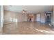 Open living space with tile flooring and access to kitchen and other rooms at 42575 W Abbey Rd, Maricopa, AZ 85138