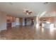 Bright living area with tile floors, high ceilings, and kitchen views at 42575 W Abbey Rd, Maricopa, AZ 85138
