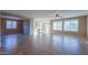 Open concept living room with tile floors and kitchen access at 42575 W Abbey Rd, Maricopa, AZ 85138