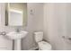 Clean bathroom with pedestal sink and toilet at 5438 W Odeum Ln, Phoenix, AZ 85043