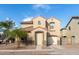 Two-story house with a beige exterior, two-car garage, and landscaping at 5438 W Odeum Ln, Phoenix, AZ 85043