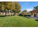 Expansive green lawn with mature trees and access to the community at 649 S Power Rd # 371, Mesa, AZ 85206