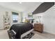 Modern bedroom with a stylish bed, a built-in desk and a geometric wall design at 7958 W Sands Rd, Glendale, AZ 85303