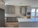 Modern kitchen with gray cabinets, white quartz countertops, and diamond pattern backsplash at 991 W Finch Dr, Queen Creek, AZ 85140