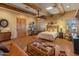 Bedroom with wooden beamed ceiling, bed, sitting area, and rustic decor at 10325 W Bayside Rd, Sun City, AZ 85351