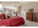 Bright bedroom with red bedding and access to a patio at 10929 E Spring Creek Rd, Sun Lakes, AZ 85248