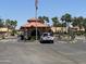 Gated entrance to community with guardhouse and palm trees at 10929 E Spring Creek Rd, Sun Lakes, AZ 85248