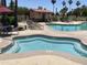 Community pool and spa with lounge chairs and tables at 10929 E Spring Creek Rd, Sun Lakes, AZ 85248