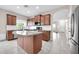 Kitchen features granite island, stainless steel appliances, and ample cabinetry at 14527 W Gelding Dr, Surprise, AZ 85379