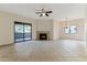 Bright living room with fireplace, tile floors, and sliding glass door to patio at 15050 N Thompson Peak Pkwy # 1012, Scottsdale, AZ 85260