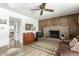 Living room features a brick fireplace, wood-paneled walls, and a view into adjacent dining area at 1522 W Puget Ave, Phoenix, AZ 85021