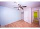 Bedroom with light blue wall and ceiling fan at 16825 N 113Th Dr, Surprise, AZ 85378