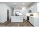 Bright kitchen featuring white cabinets, stainless steel appliances, and an island at 17705 W Mission Ln, Waddell, AZ 85355