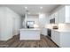 Modern kitchen with white cabinets, stainless steel appliances, and an island at 17705 W Mission Ln, Waddell, AZ 85355