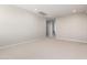 Spacious bedroom with neutral carpeting and access to hallway at 19743 W Exeter Blvd, Buckeye, AZ 85340