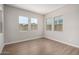Spacious bedroom with wood-look floors and large windows offering ample natural light at 19743 W Exeter Blvd, Buckeye, AZ 85340