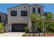 Two-story house with gray siding, brown garage door, and landscaping at 19743 W Exeter Blvd, Buckeye, AZ 85340