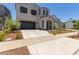 Two-story house with gray siding, brown garage door, and landscaping at 19743 W Exeter Blvd, Buckeye, AZ 85340