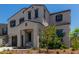Two-story house with gray siding, brown garage door, and landscaping at 19743 W Exeter Blvd, Buckeye, AZ 85340
