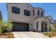 Two-story house with gray siding, brown garage door, and landscaping at 19743 W Exeter Blvd, Buckeye, AZ 85340