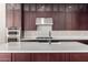 Kitchen boasts dark cabinetry, quartz countertops and stainless steel appliances at 19743 W Exeter Blvd, Buckeye, AZ 85340