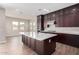 Modern kitchen with dark wood cabinets and expansive quartz countertops at 19743 W Exeter Blvd, Buckeye, AZ 85340