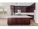Modern kitchen with dark cabinets, quartz countertops and stainless steel appliances at 19743 W Exeter Blvd, Buckeye, AZ 85340