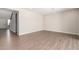 Spacious living room with wood-look floors and access to hallway at 19743 W Exeter Blvd, Buckeye, AZ 85340