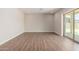 Living area with wood-look floors and sliding glass door to backyard at 19743 W Exeter Blvd, Buckeye, AZ 85340