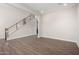 Bright living room with wood-look floors and modern staircase at 19743 W Exeter Blvd, Buckeye, AZ 85340