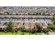 An aerial view of a community with single-story homes, lush green landscaping, and streets at 2064 S Farnsworth Dr # 46, Mesa, AZ 85209