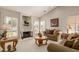 Living room with beige sofas, coffee table, and fireplace at 26606 S Foxglenn Dr, Sun Lakes, AZ 85248