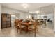 Bright dining room features a wood table with chairs, and a mirrored wall reflecting the living room at 4442 E Walatowa St, Phoenix, AZ 85044