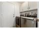 Laundry room with LG washer and dryer, cabinets, and a door at 4442 E Walatowa St, Phoenix, AZ 85044