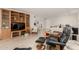 Relaxing living room with comfortable seating, built-in shelving, and a large TV at 4442 E Walatowa St, Phoenix, AZ 85044