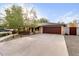 Attached garage with a wood-like door and ample driveway space at 7538 N 17Th Dr, Phoenix, AZ 85021