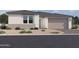 Single-story home with a two-car garage and desert landscaping at 7631 W Tether Trl, Peoria, AZ 85383